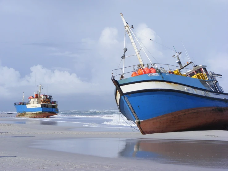 two ships at the waters edge on a beach