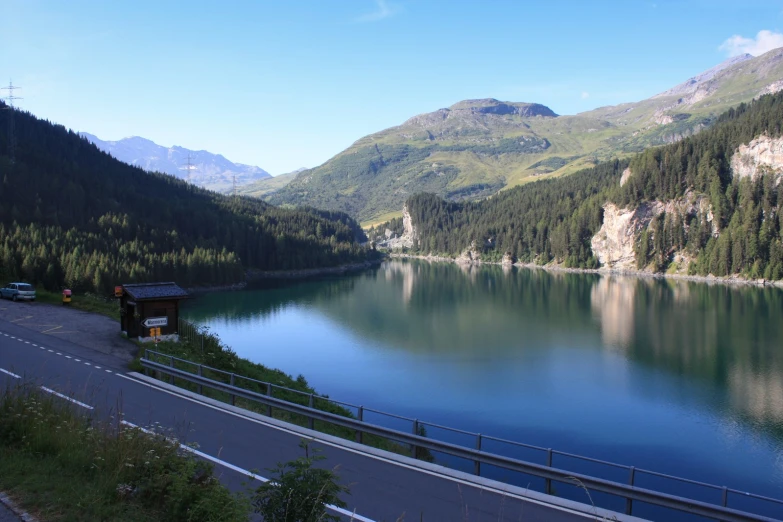 a body of water with mountains and a sky background