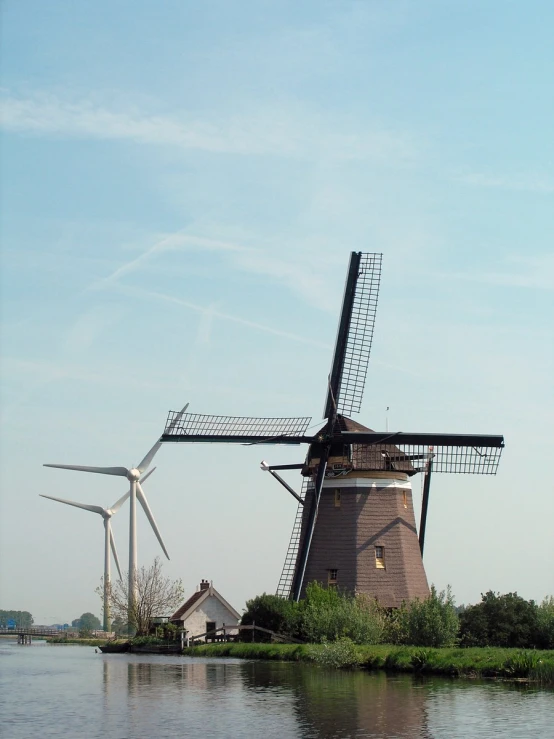 the two windmills next to each other on the water