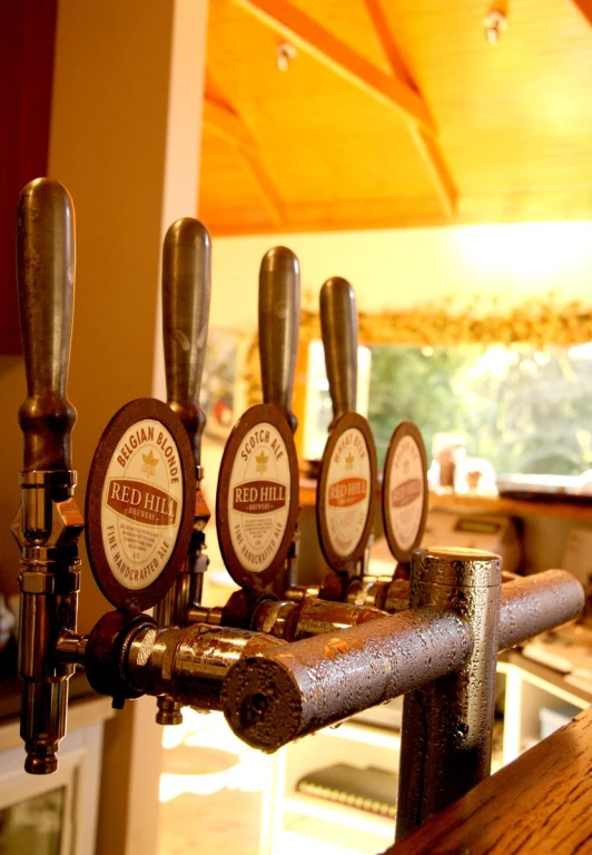 a row of beer taps in a kitchen next to a window