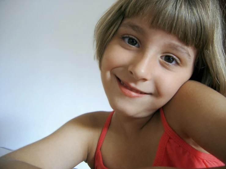 a girl posing for the camera with her hair up