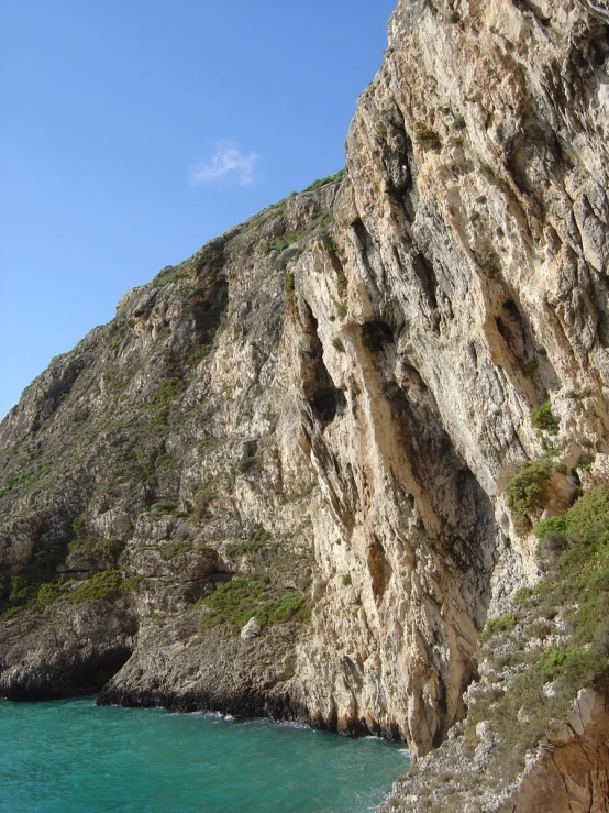 a cliff that looks like it has been carved from the rock wall