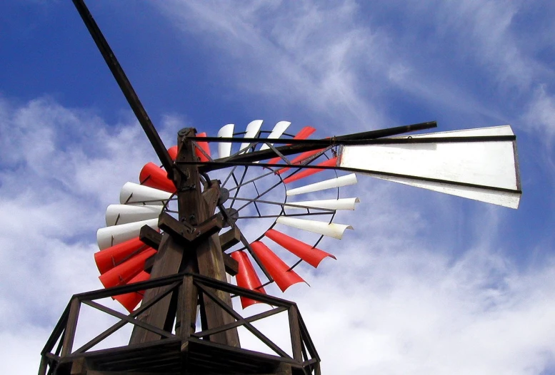 this is the side view of a windmill against a blue sky