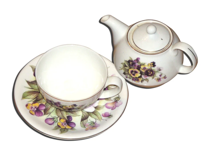 two tea cups and a saucer are decorated with pansies