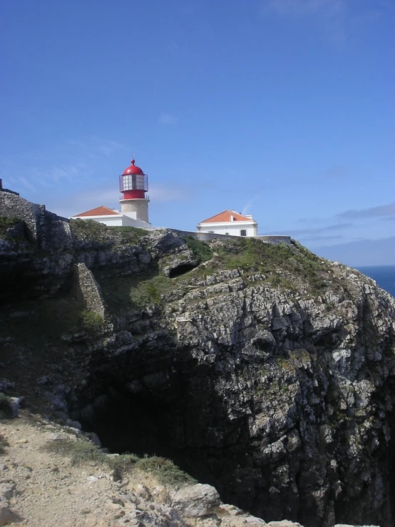 lighthouses are seen on top of an rocky cliff