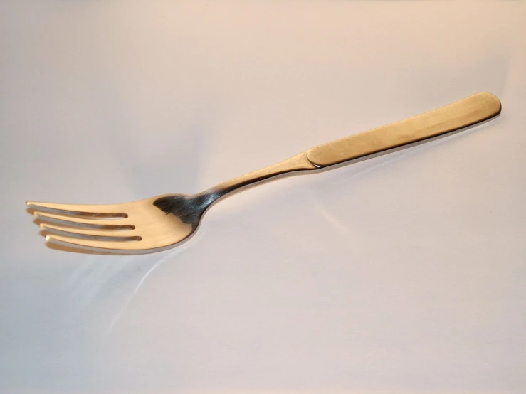 a fork with a metal handle made from solid ss