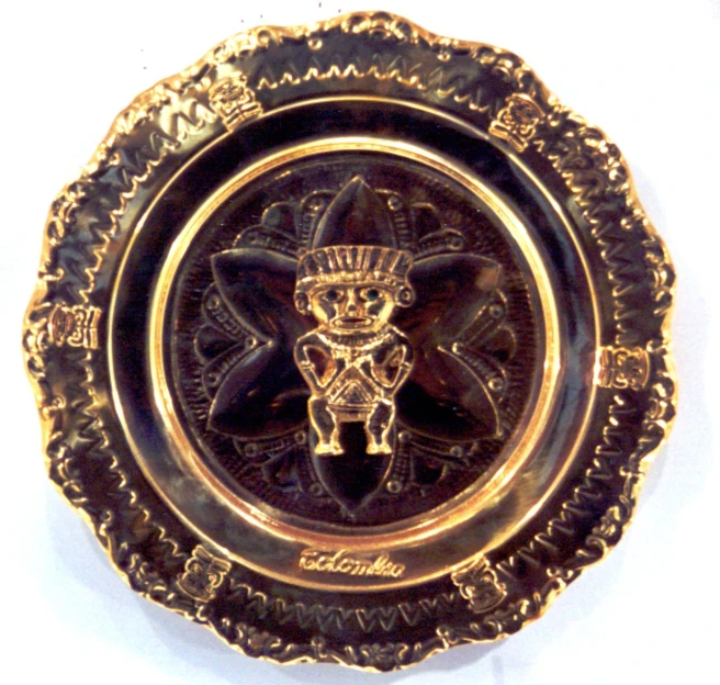 a gold metal emblem of a monkey with a crown