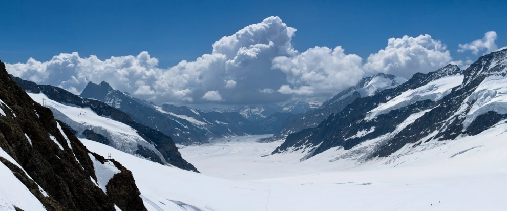 snowy mountains with ice and snow, with blue skies and clouds