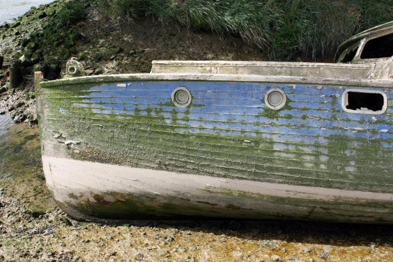 an old boat is painted green and white