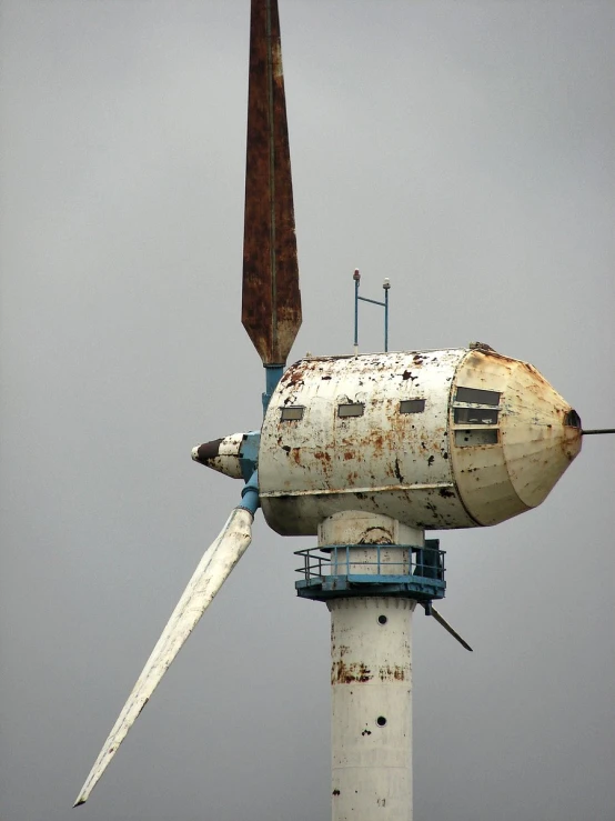 a rusty windmill has rusted and stained white