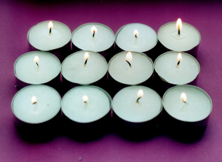 many candles in various shapes and sizes, arranged together