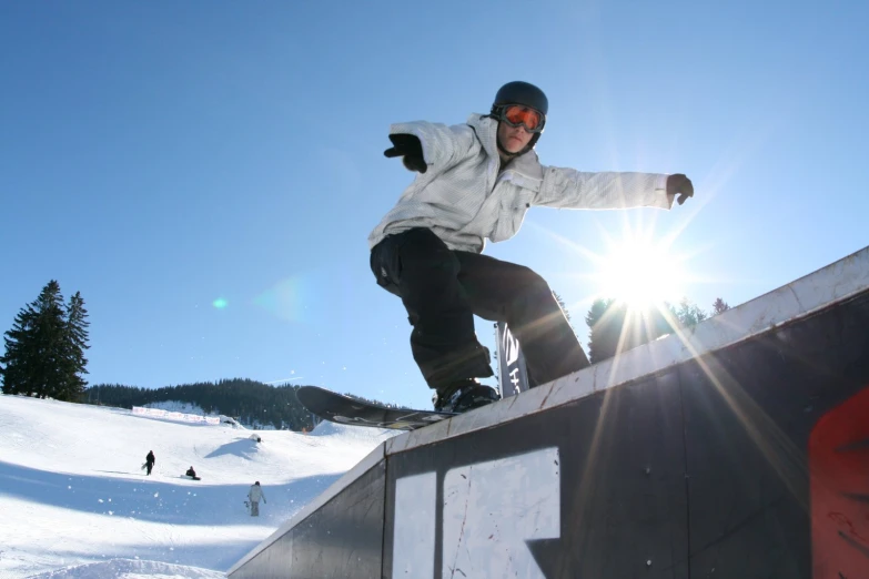 a man standing on top of a skateboard ramp