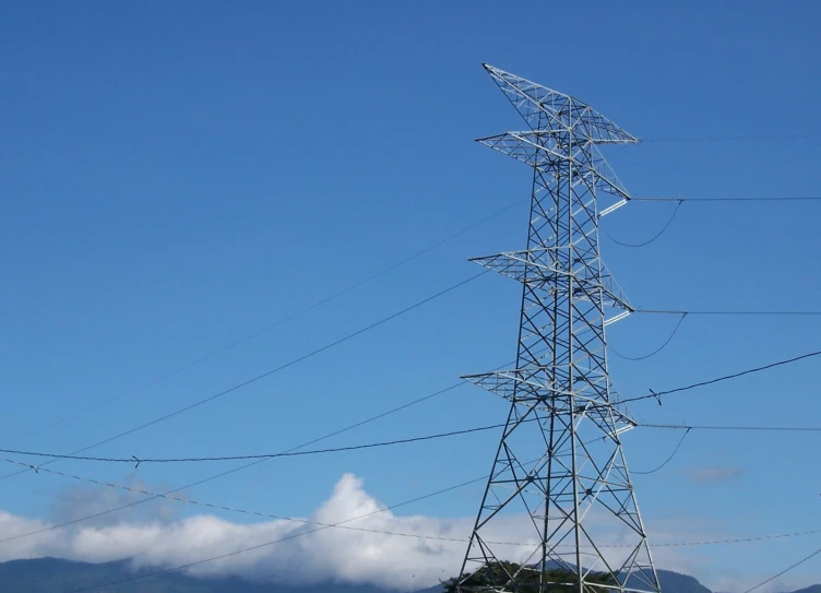 a large tall electrical tower standing next to a mountain