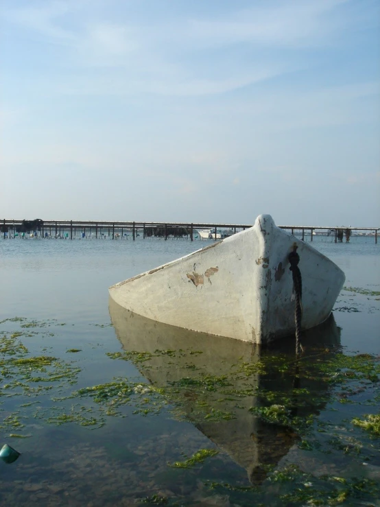 a white boat in the middle of some water