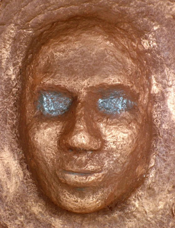 a statue with the face of a man made of sand