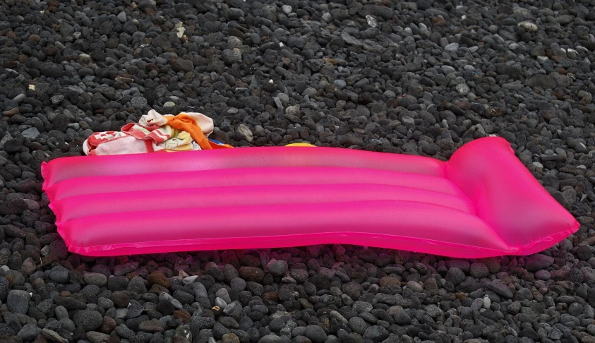 an inflatable item that looks like an intringue boat is laying on the ground