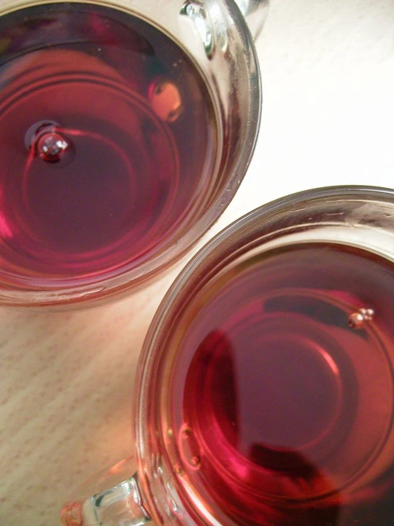 wine in two glass cups on a table