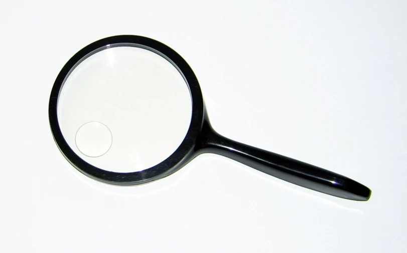 close up of a magnifying glass with a white background