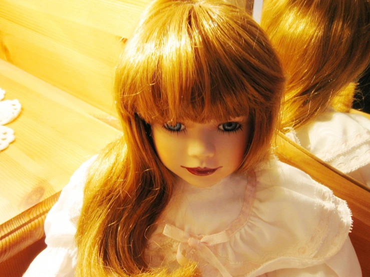 a little girl in a white dress with big bangs and brown eyes