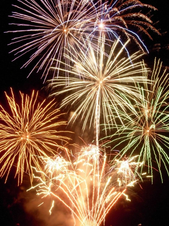 bright fireworks bursting over water during the night sky