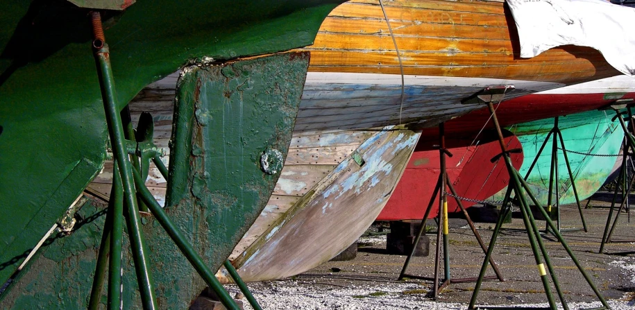 the side of a group of boats, painted and parked