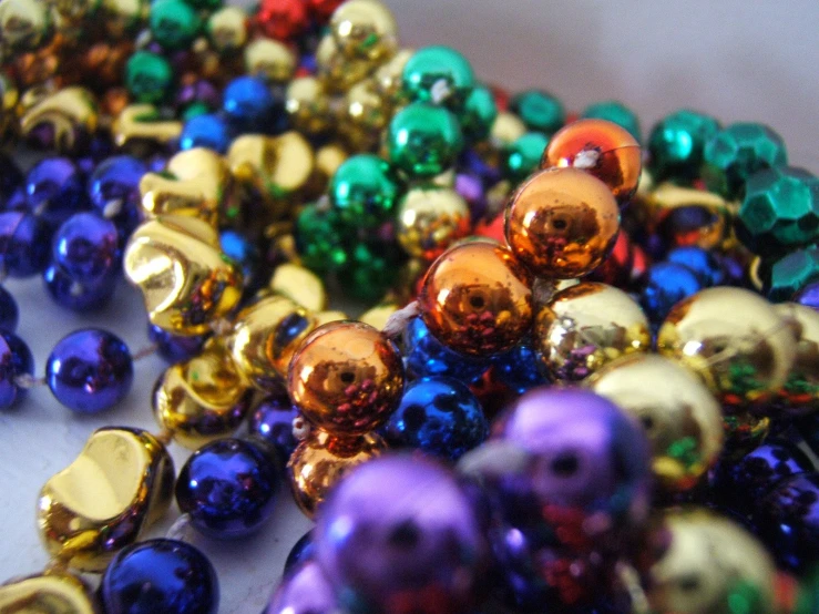 closeup of beads and jewelles on white surface