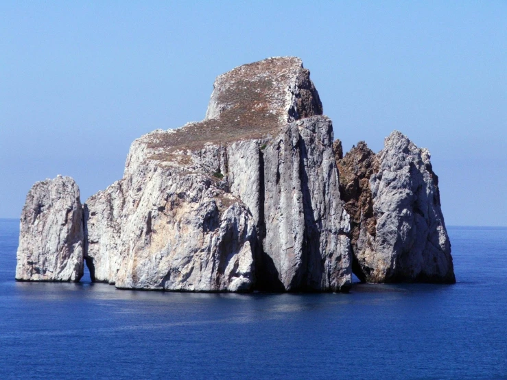 the rocks are made of stone and stand in the water