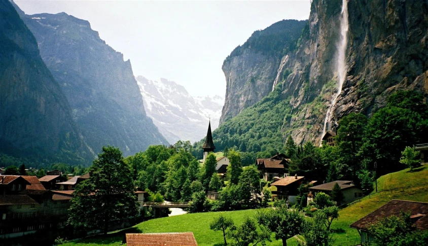 mountains and a village surround a valley