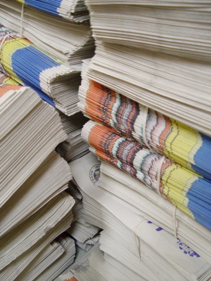 large stack of magazines with folded pages stacked on top