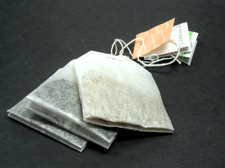 a pair of brown paper bags sit on a black surface