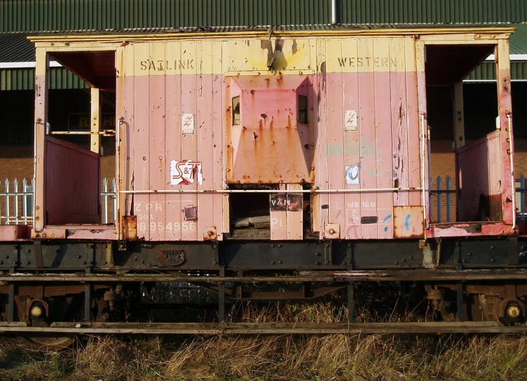 the caboose has been abandoned and is sitting on a railroad track