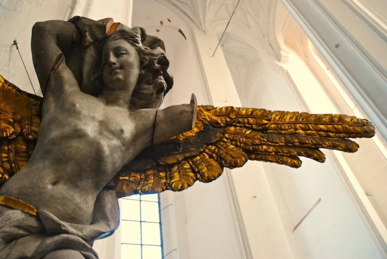 there is a statue that has gold wings