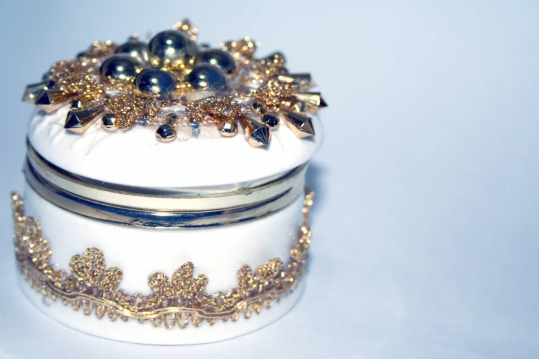 a round, white box with some gold accents