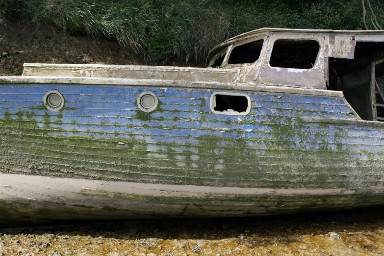 an old abandoned fishing boat on the ground