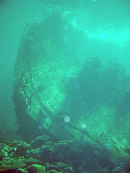 an old wreck is sitting under water