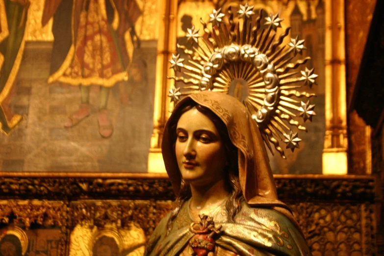 the statue of mary is displayed on the wall