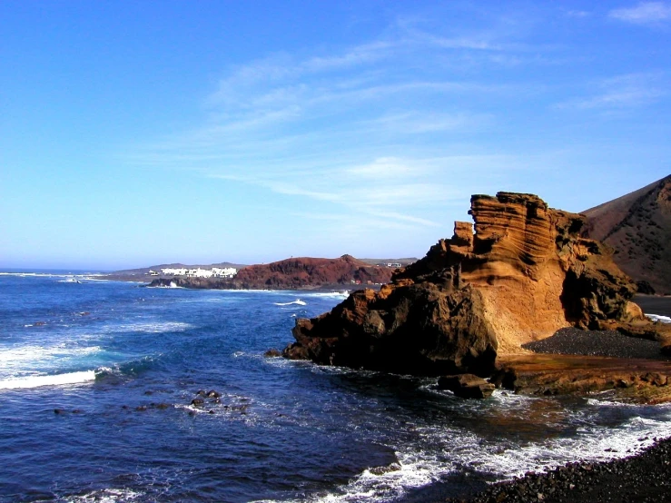 a view from the coast, looking toward the water and hills