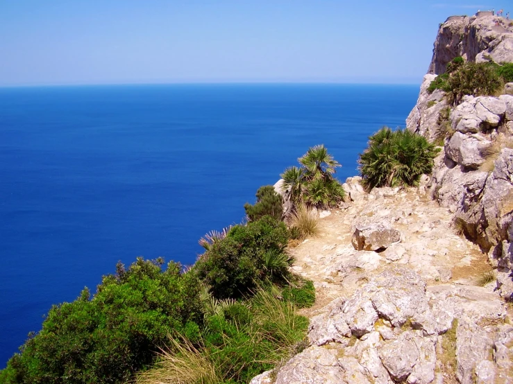 a rocky cliff is overlooking the ocean