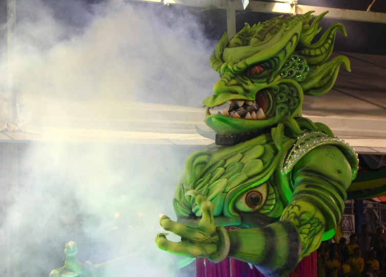 a green dragon head statue standing on top of a stage