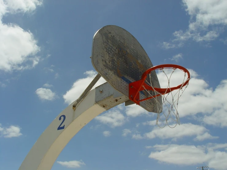 a basketball hoop in the middle of an outdoor court