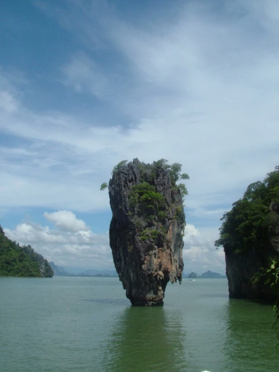 an island surrounded by trees in the ocean