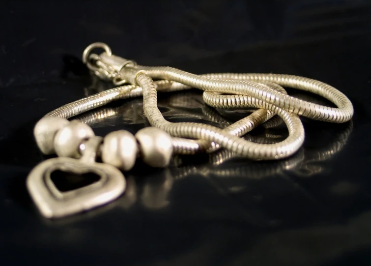 a bunch of silver beads sitting on top of a table