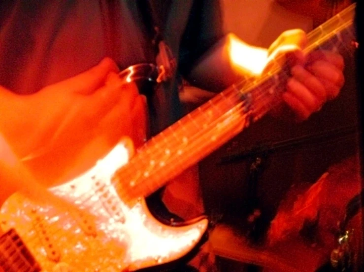 a close up of someone playing an electric guitar