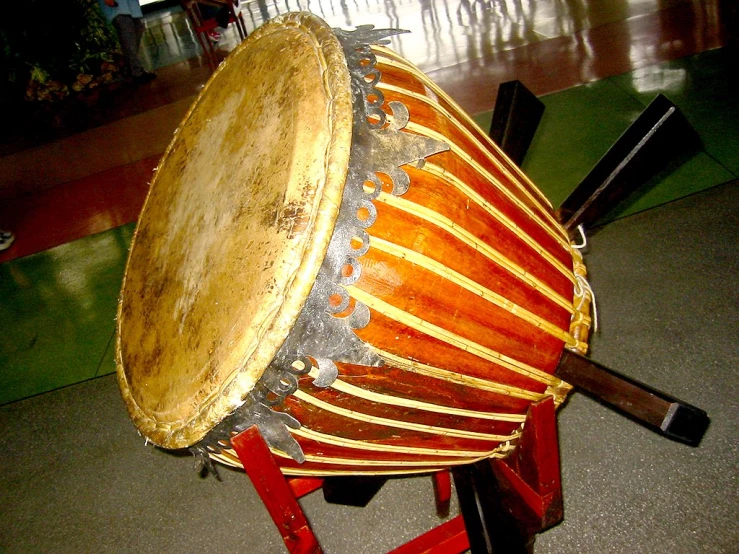 a big wooden drum on a stand at a musical event