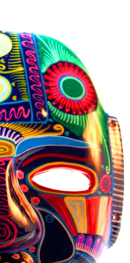 a large multi - colored mask that is on display