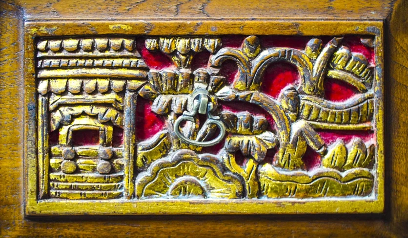 an ornate carving is on display on the wall