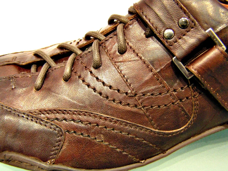 a brown shoe has two zippers on it