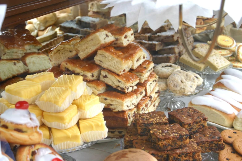 various pastries are displayed on a tray in a bakery