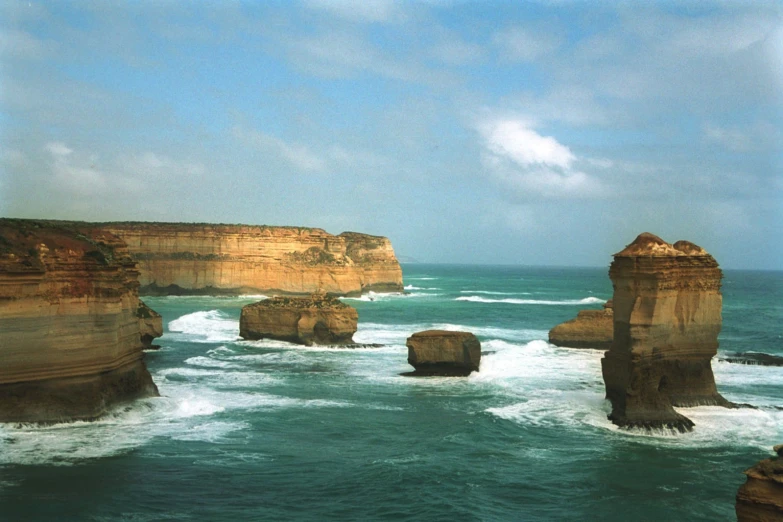 waves come in near the rugged rock formations at a cliff overlook