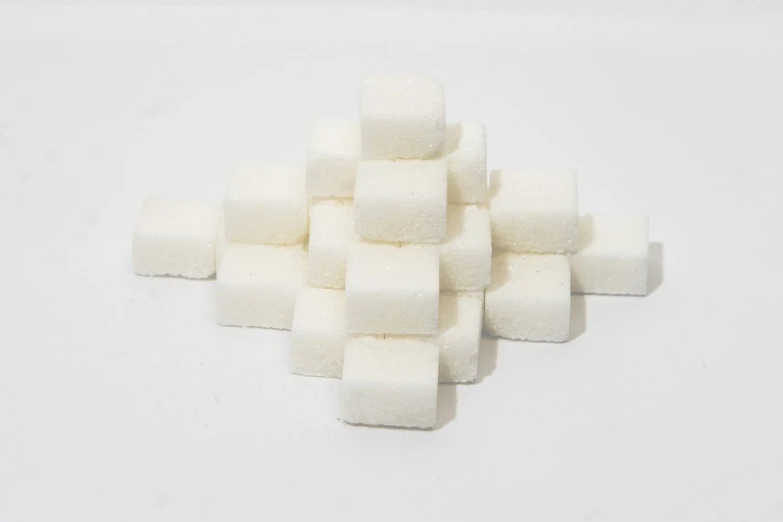 a pile of sugar cubes sitting on top of a white table